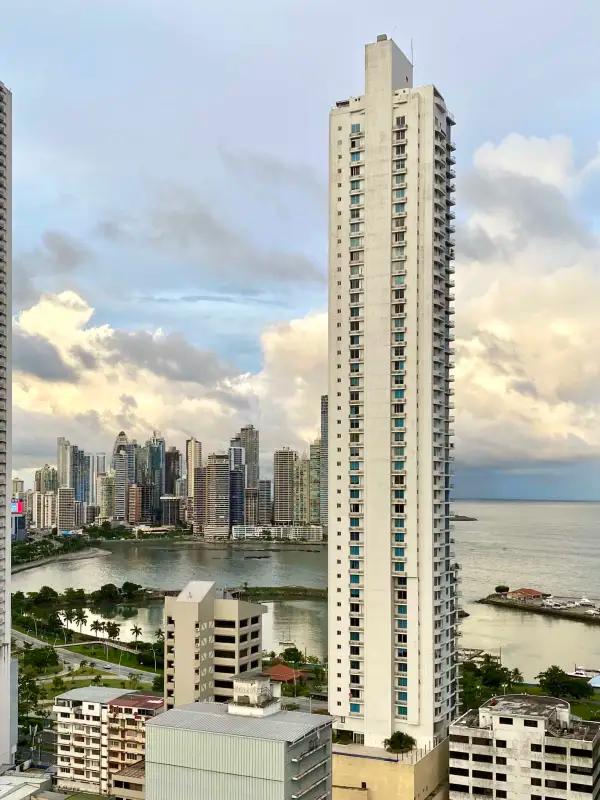 Furnished master bedroom with AC, closet, and city window view in PH Bay View Tower Bella Vista Panama