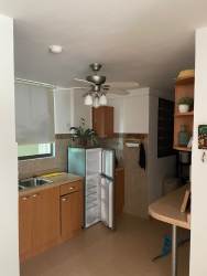 Contemporary kitchen with light cabinets breakfast bar appliances in PH Ocean Front Nueva Gorgona