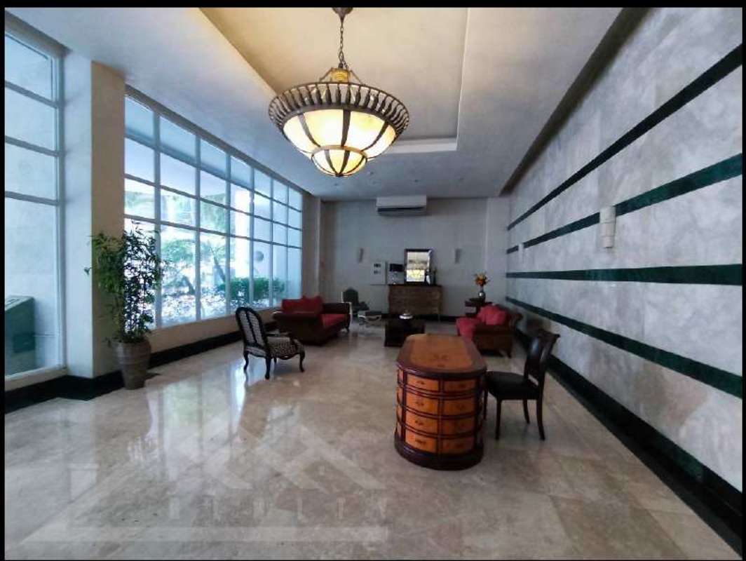 Double-height lobby with reception, marble floors in PH Bella Vista Residences Panama City