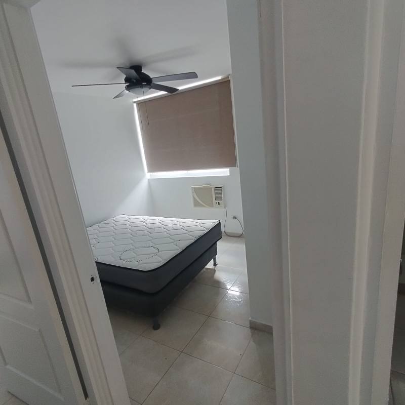 Bedroom featuring window view, tiled floors, AC in PH Elmare Edison Park