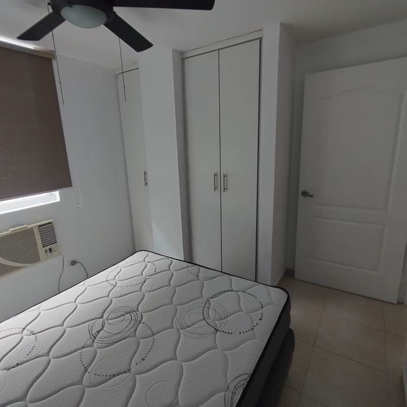 Bedroom with built-in closet, ceiling fan, neutral decor in PH Elmare Panama City
