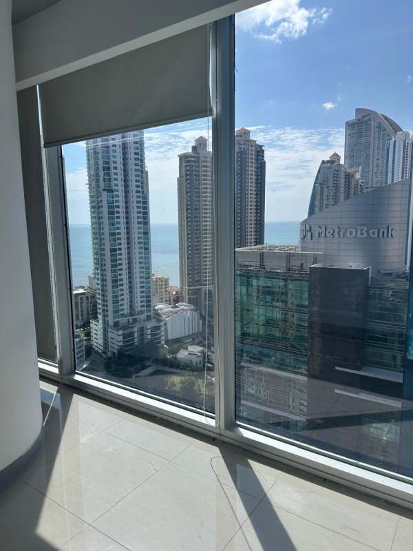Interior of high-rise office/apartment living area with ocean view in Oceanía Business Plaza