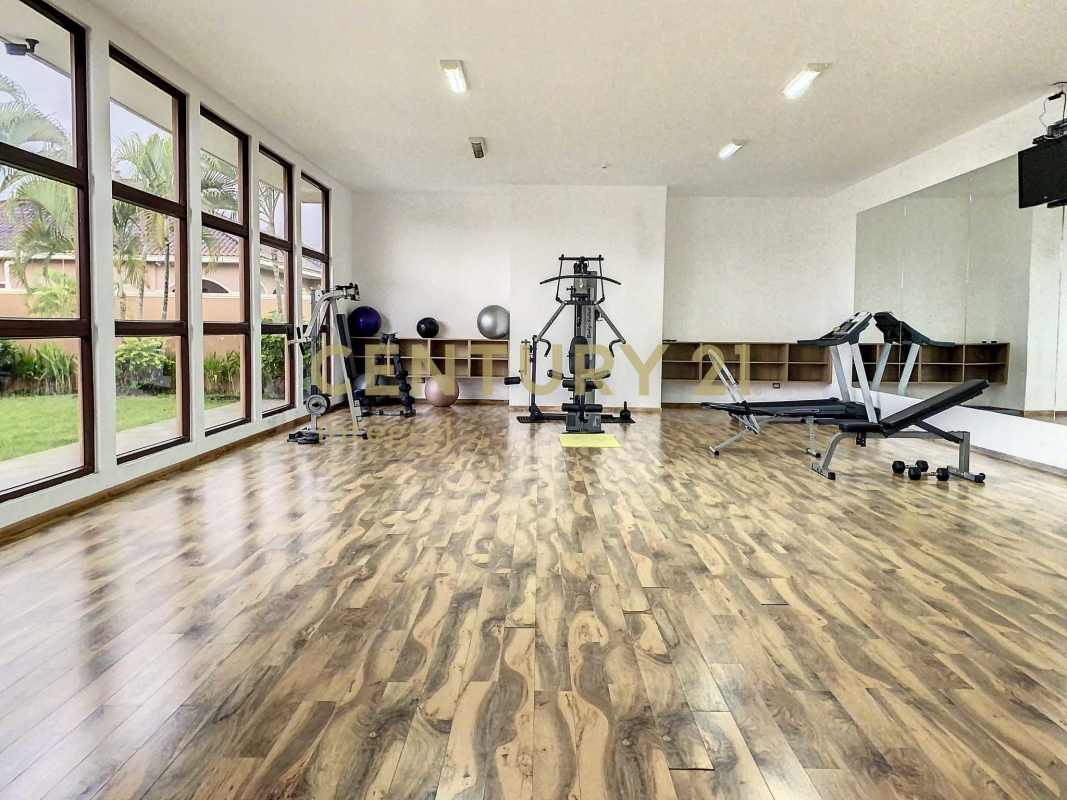 Contemporary dining area with tray ceiling, large windows, and wood floors in PH Sunset Coast Costa Sur Panama
