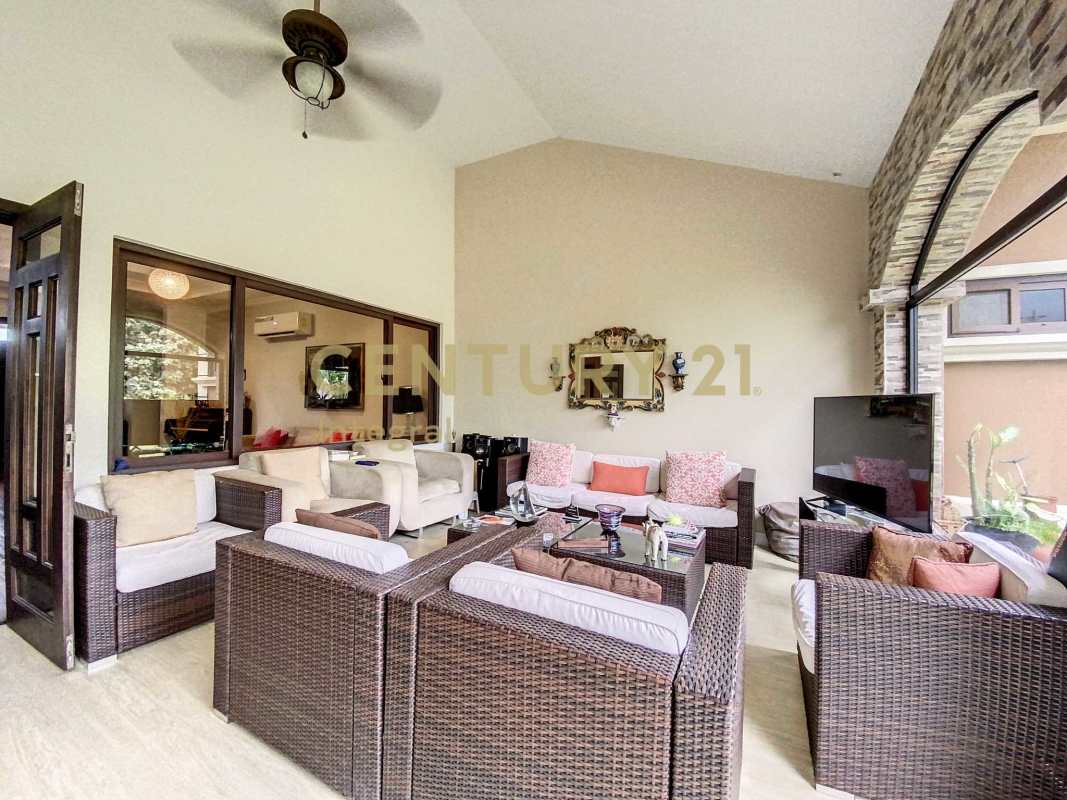 Bright sunroom with wicker furniture and vaulted ceiling in PH Sunset Coast Costa Sur Panama