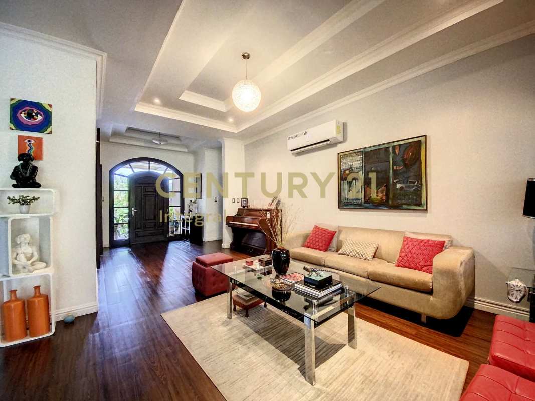 Spacious living area with tray ceiling, hardwood floors and modern decor in PH Sunset Coast Panama