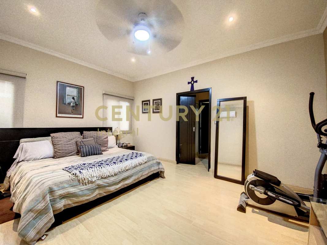 Bedroom with workout area, large mirror, ceiling fan in PH Sunset Coast Costa Sur Panama