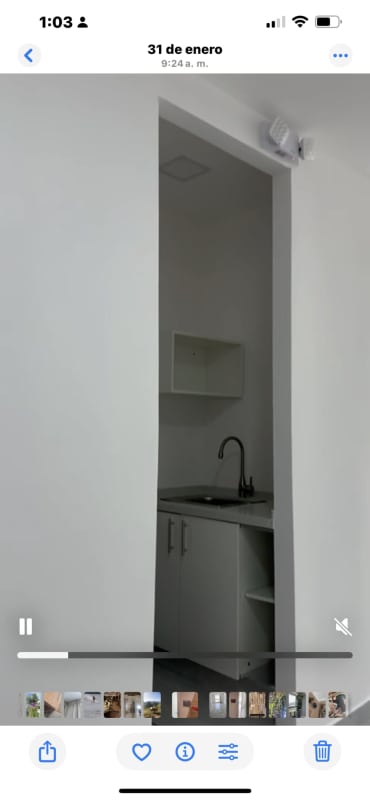 Compact kitchenette area with white cabinetry, modern sink, open shelves in Town Center Costa del Este office