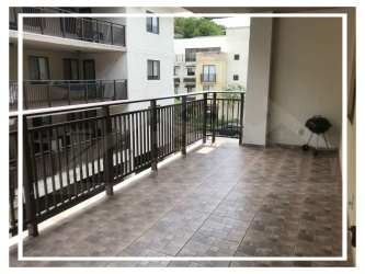 Large balcony with metal railing overlooking Panama Pacifico community at PH Midrise
