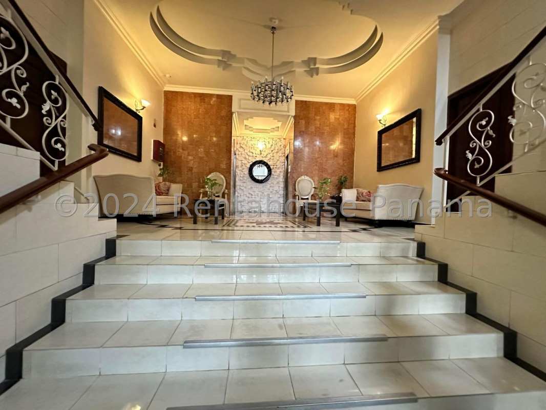 Elegant lobby with chandelier, marble floors, and seating area at PH Tamanaco Punta Paitilla Panama