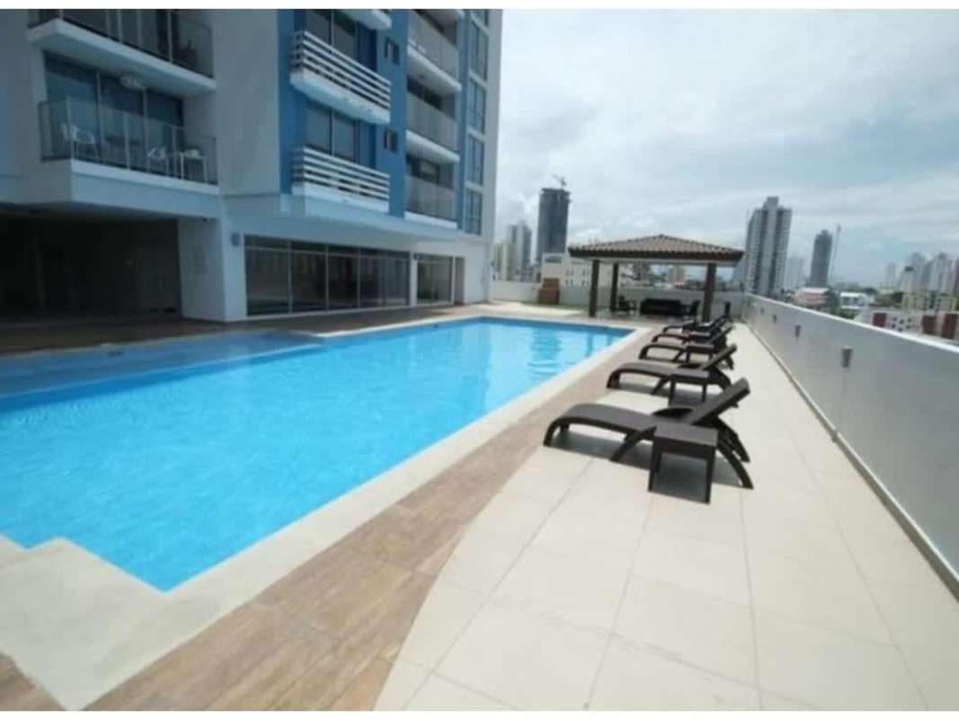 Rooftop swimming pool with lounge chairs and skyline view in Panama City