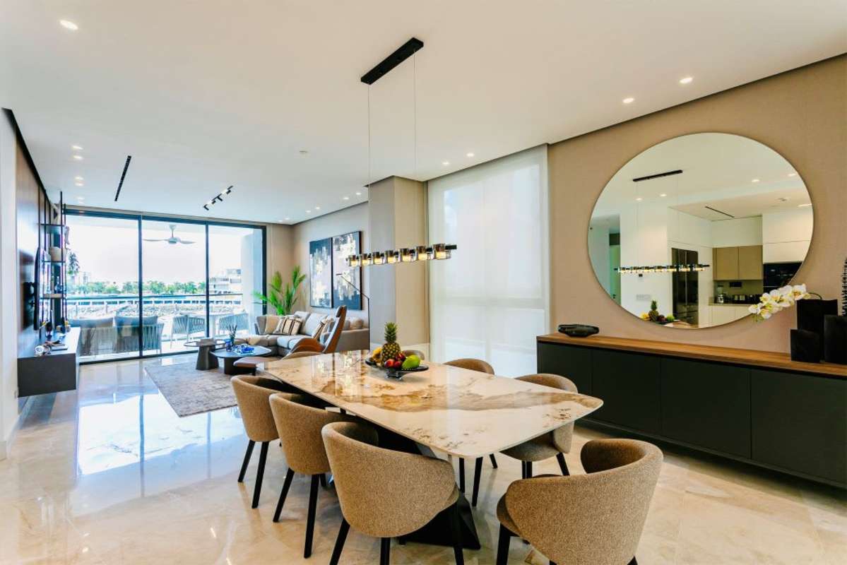 Elegant living and dining area with floor-to-ceiling windows, marina views at Casa del Mar Ocean Reef Panama