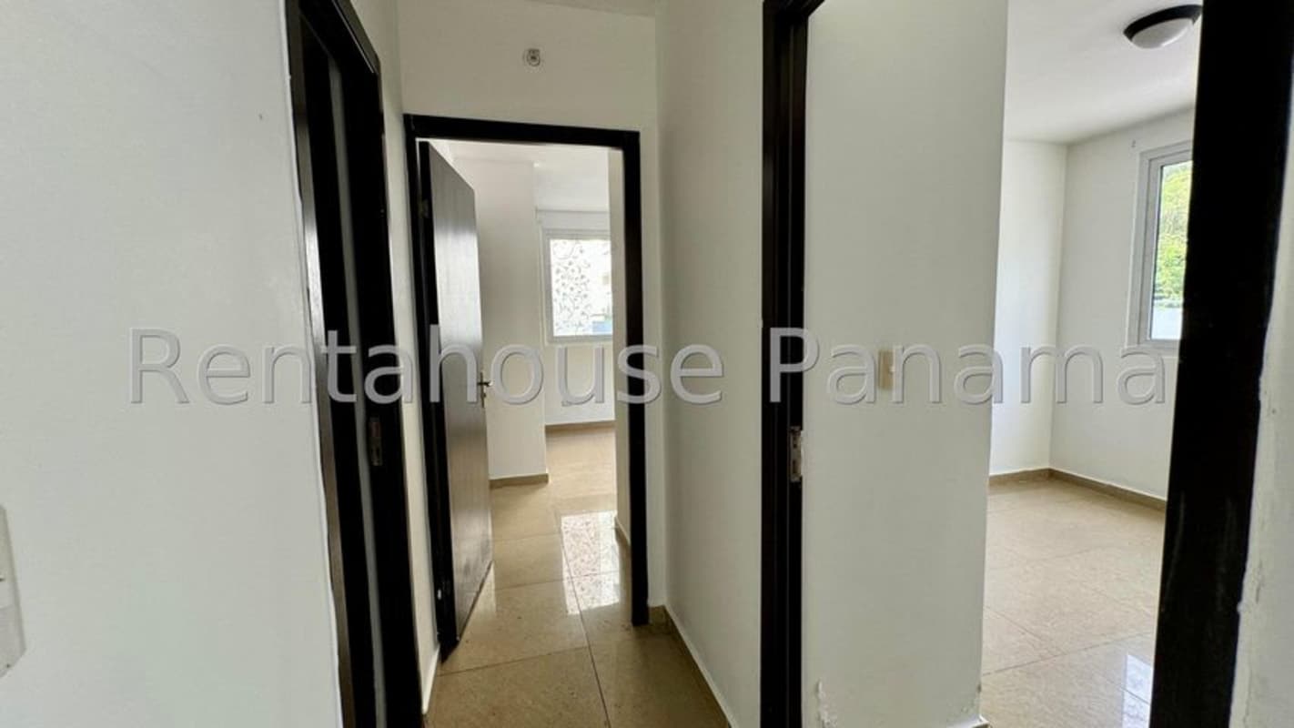 Hallway with beige tile flooring and natural light inside apartment PH Urbis Tower Panama