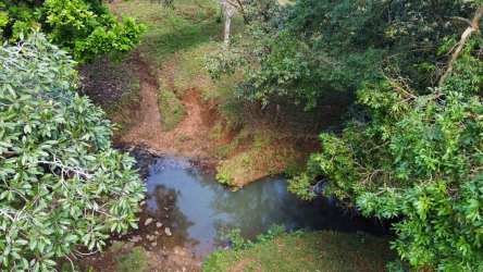 Small river creek inside large agricultural property La Chorrera Panama natural water feature