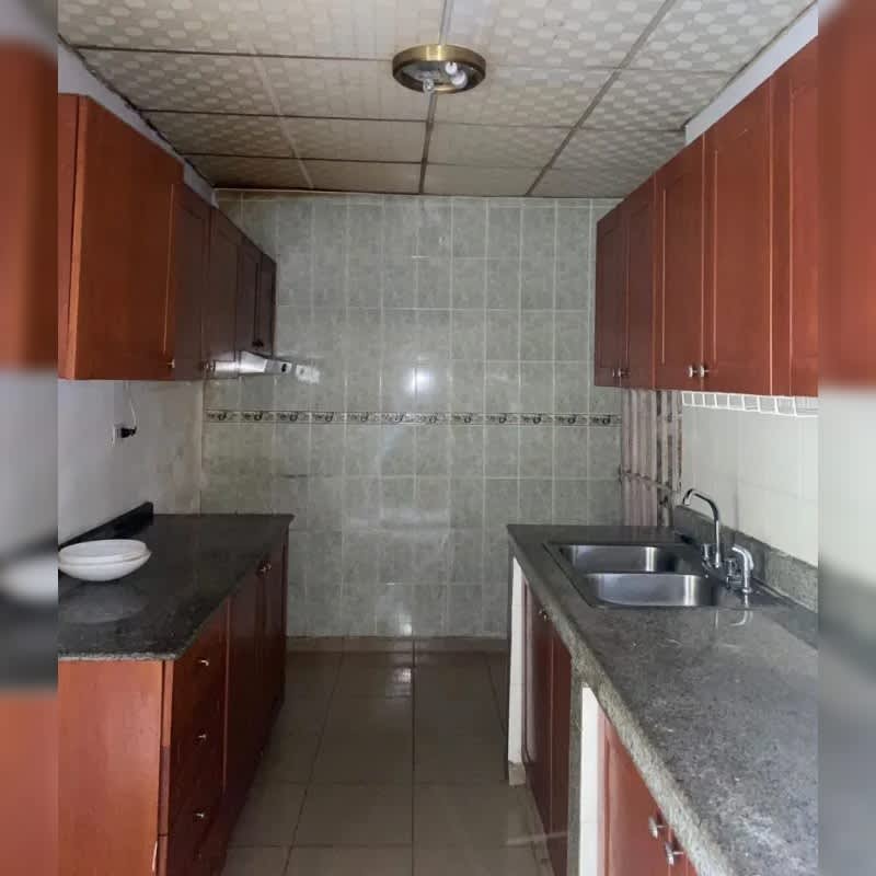 Traditional kitchen with granite counters, double sink, wood cabinets in rental house Villa Lucre El Crisol Panama