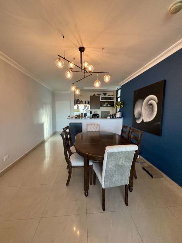 Contemporary dining area with accent wall and chandelier in PH Pacific Point Punta Pacifica Panama