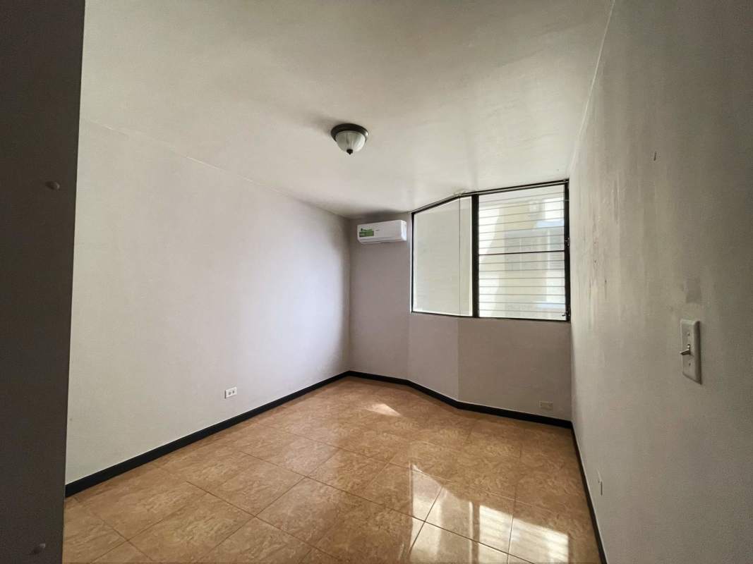 Bedroom with large window, built-in wardrobe, ceramic tile floor and AC in Villa de las Fuentes Panama City