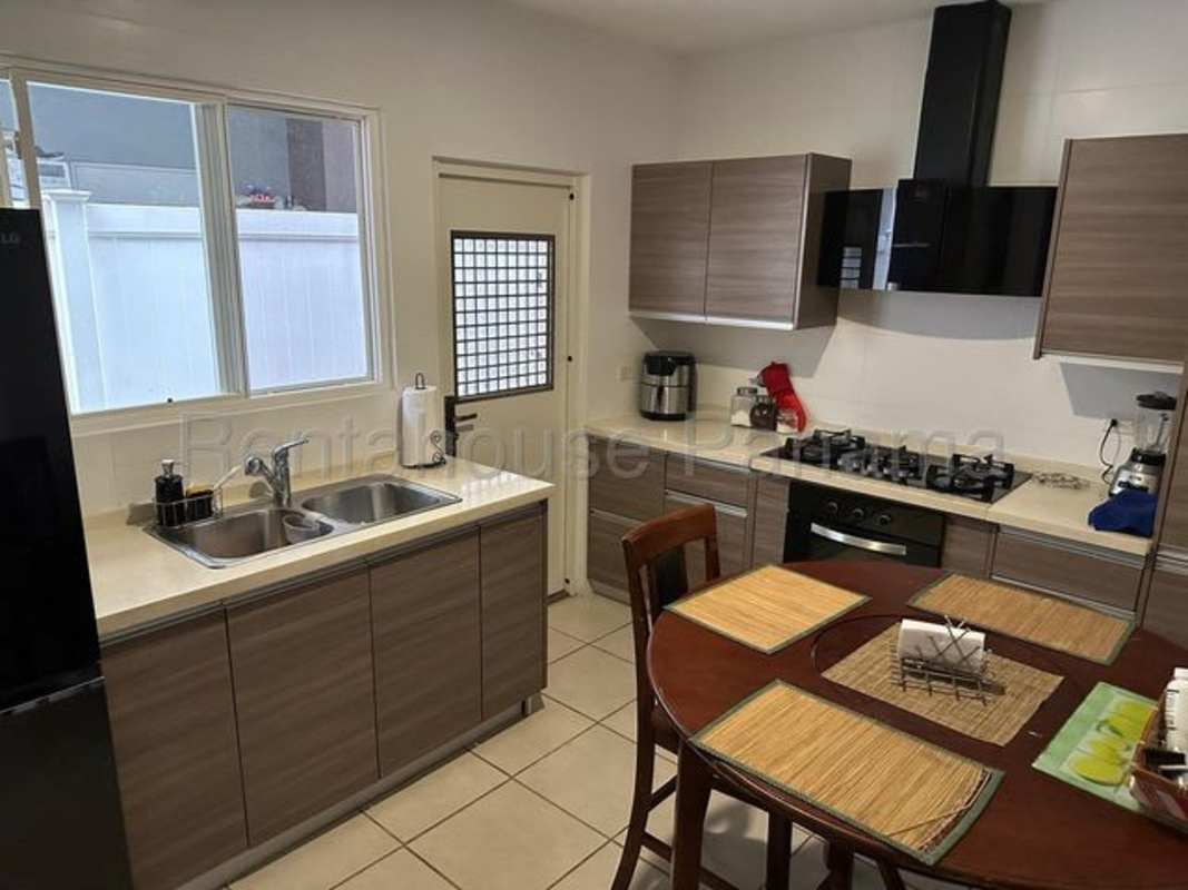 Contemporary kitchen with wood cabinets, gas stove, oven PH Victoria Brisas del Golf Panama