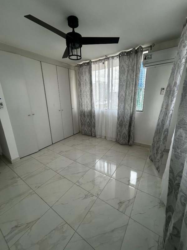 Modern second bedroom with sleek tile floors, AC unit, large window, in PH Brisas de San Fernando Panama