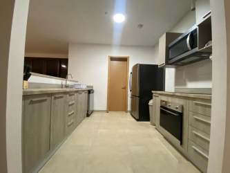 Kitchen space with wood cabinetry and stainless appliances Nueva Gorgona beachfront apartments