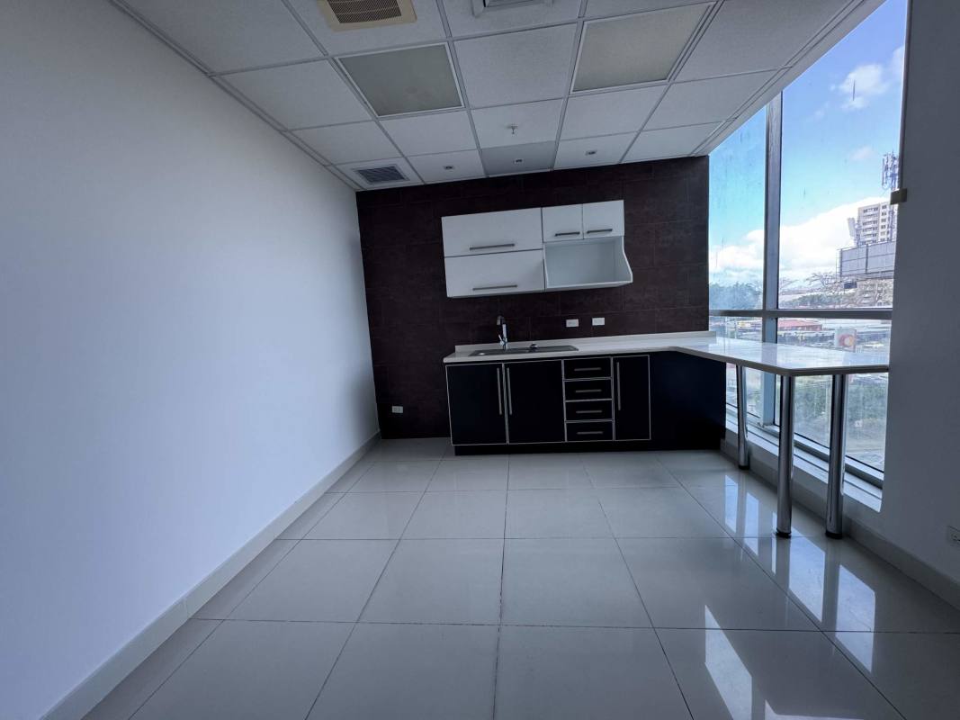 Bright kitchenette with corner windows in commercial Costa del Este office tower Panama