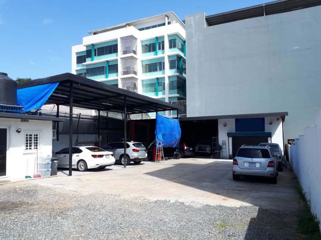 View of parking area with nearby residential buildings on land for sale in Panama
