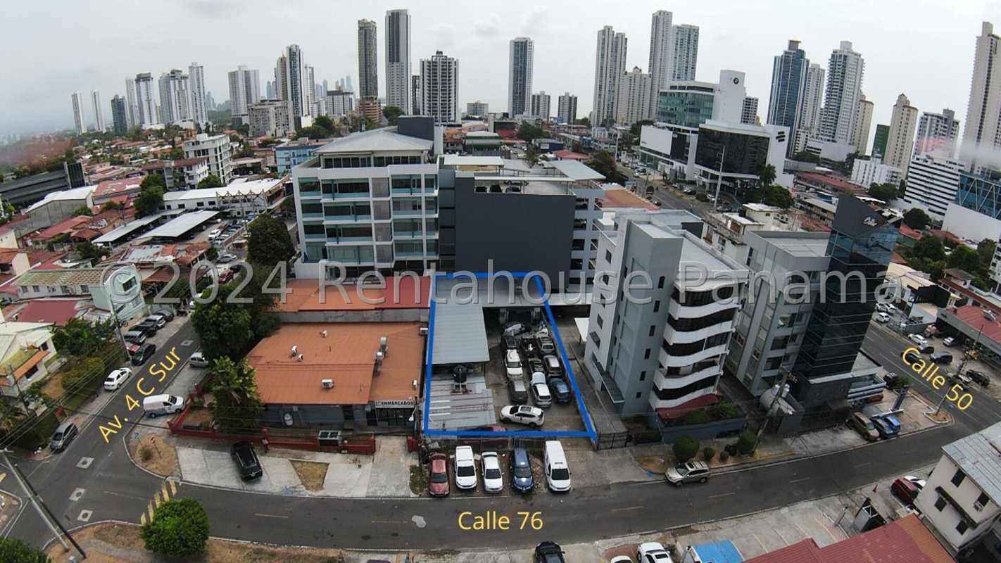 Aerial of central Panama City with parking lot and city skyline prime location land