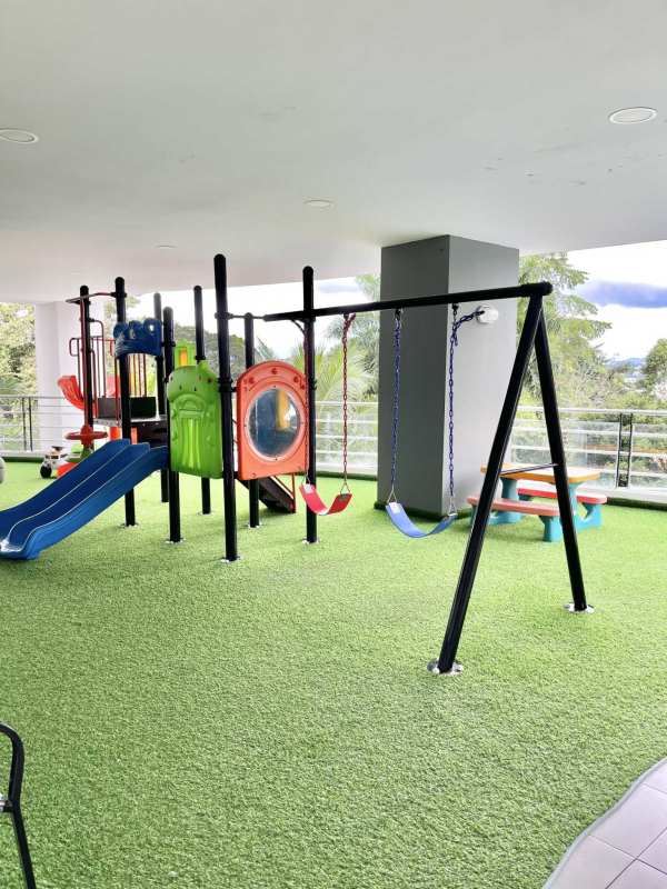 Children's recreational play area with swings and slide at PH La Cresta