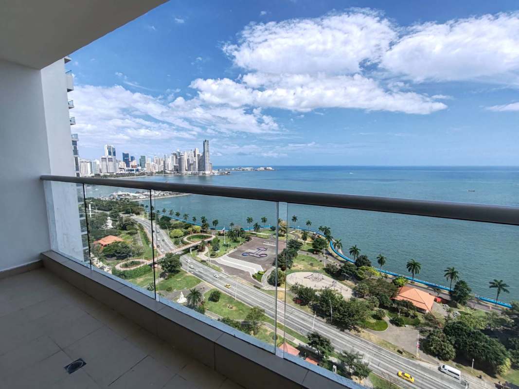 Master bedroom with panoramic windows sea and skyline view at PH Rivage Tower Panama City