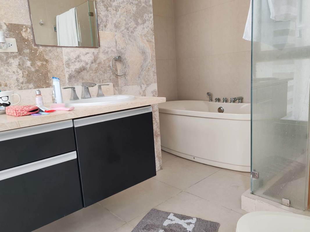 Modern bathroom with granite countertops and glass shower PH Rivage Panama City