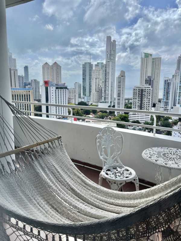 Swimming pool with lounge chairs surrounded by palm trees in PH La Cresta Panama City
