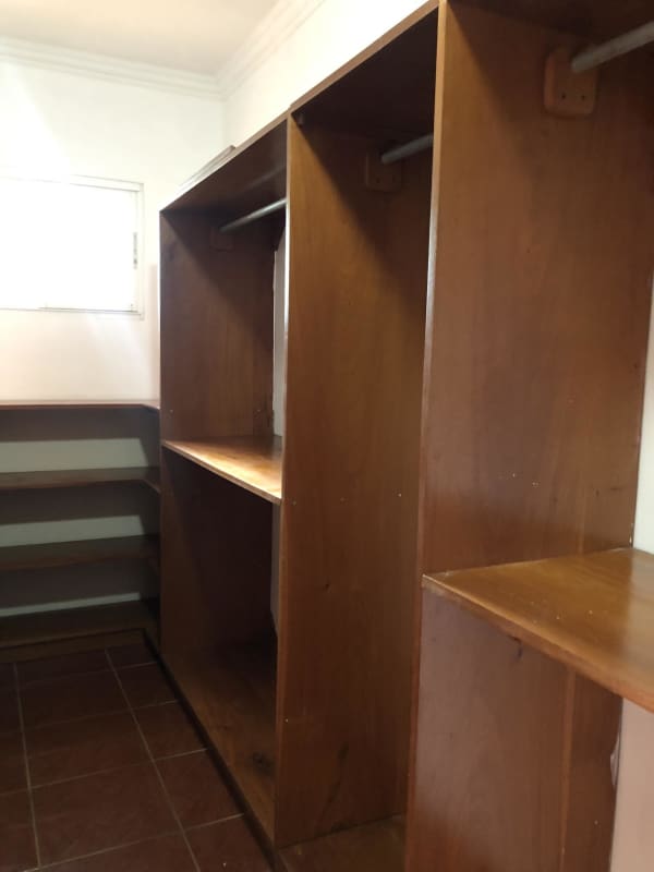 Spacious walk-in closet built-in shelves wooden organizers Llano Bonito Panama