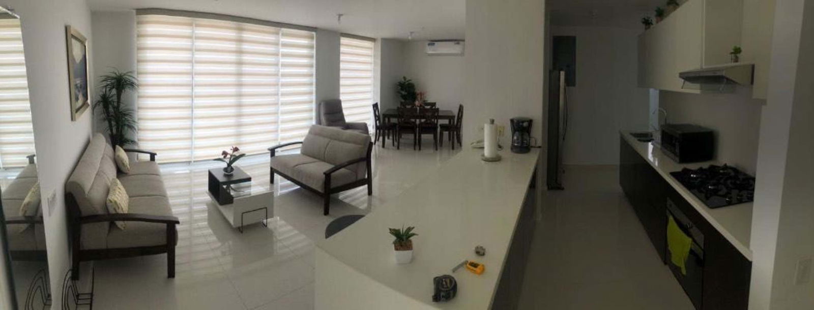 Modern kitchen with breakfast bar and dining area PH Porto Alegre Panama City