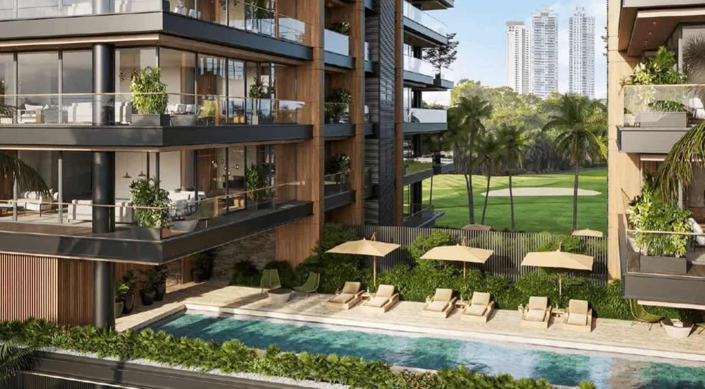 Luxury condo exterior with swimming pool, sun loungers, lush landscaping PH Quintessence Panama