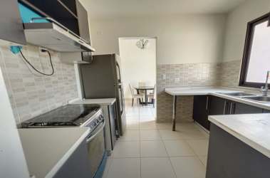 Open plan living dining room with ceiling fan and large windows in PH Summer Hills Panama