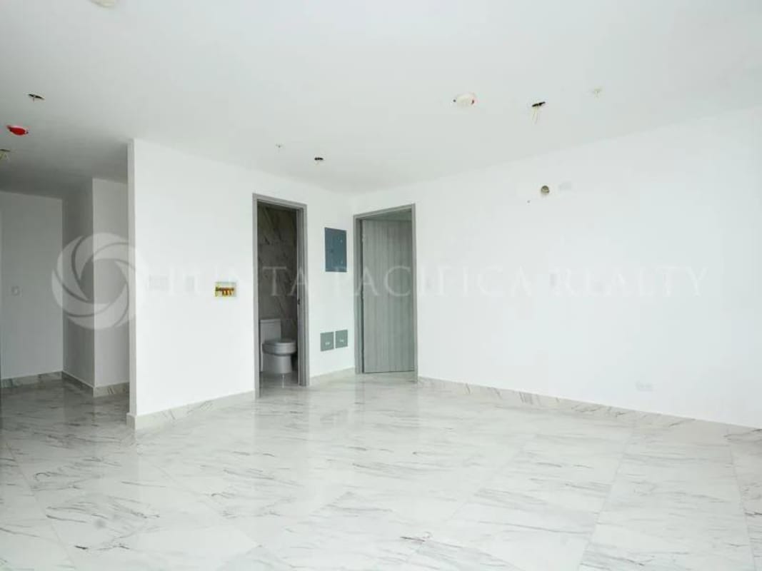 Bright living room with marble floor and sliding glass door to balcony in PH El Botánico Bella Vista Panama