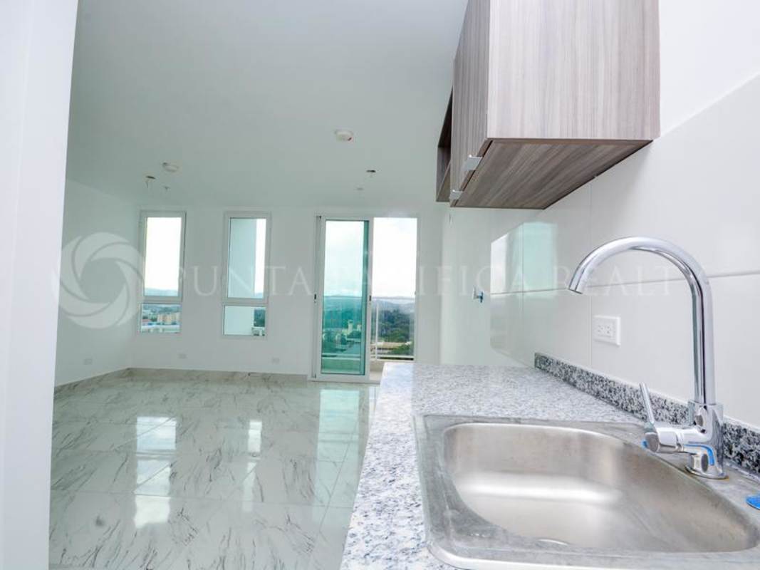 Integrated kitchen and living room with balcony access in PH El Botánico Bella Vista Panama