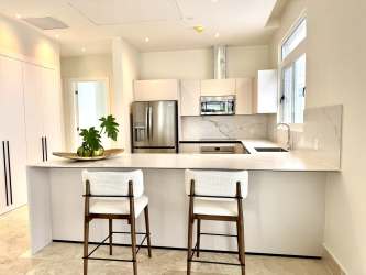 Sleek modern kitchen with marble backsplash and stainless appliances at Marina Gardens Buenaventura Panama