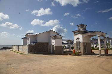 Gated community entrance with ocean view security booth Playa Dorada Panama