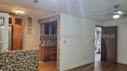 Open kitchen with modern finishes connected to living dining area in Arboleda Los Olivos house Panama