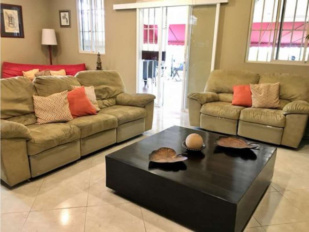 Dining area with elegant chandelier and wood cabinetry in Betania family home