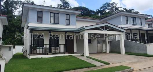 Two-story duplex exterior with balcony, covered parking, landscaped lawn Costa Verde Panama