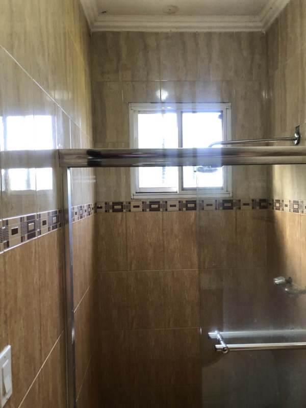 Bathroom with walk-in shower glass divider beige tiles La Toscana Panama House