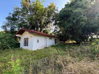 Small rustic home surrounded by mature trees near beach Coronado Panama ideal for renovation or redevelopment