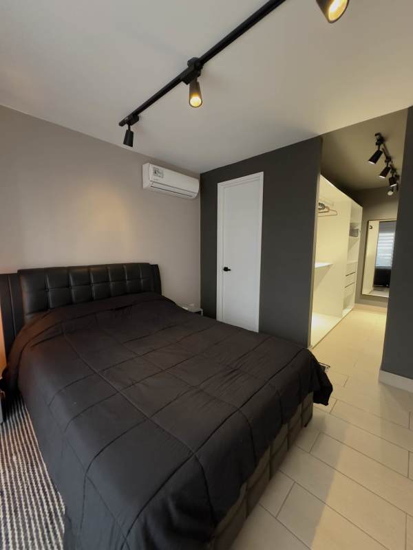 Stylish bedroom with walk-in closet, track lighting and AC Living73 Tower San Francisco Panama