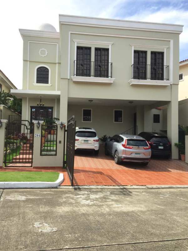 Granite kitchen with breakfast area and wooden cabinetry in Altos de Panamá house