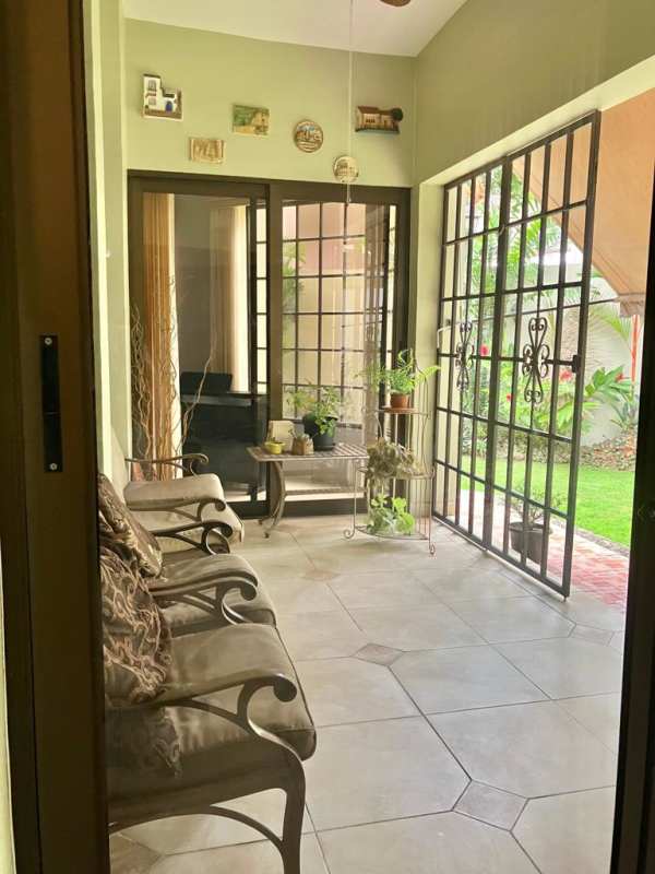 Large living dining area with marble flooring, decorative columns, chandelier in Condado del Rey