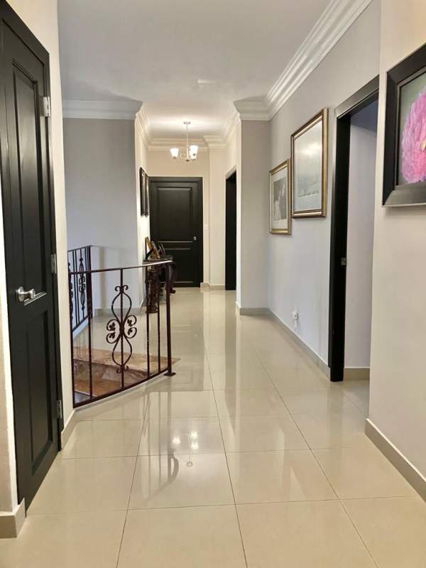 Double height entrance with marble stairs, chandelier in Condado del Rey home
