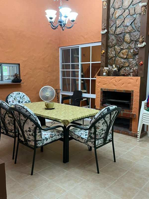 Living and dining room with exposed beams, large windows, nature views mountain house Panama