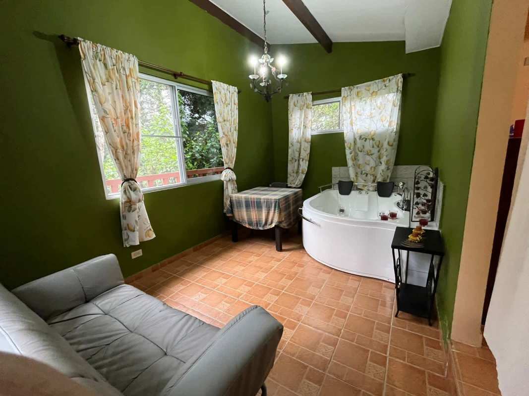 Indoor jacuzzi relaxation room with large windows and forest views mountain home Panama
