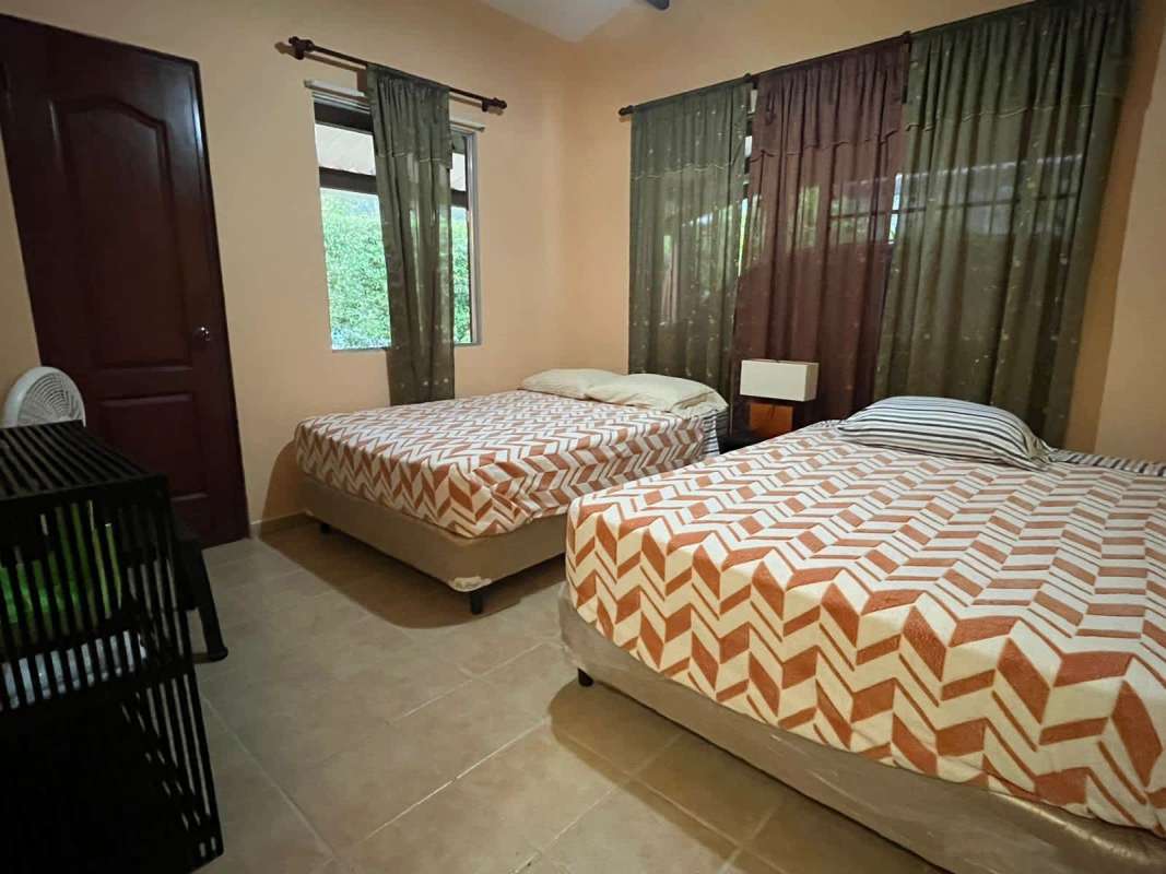Bedroom with twin beds, crib, bright and airy mountain house Cerro Azul